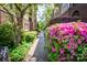 Charming brick walkway lined with lush greenery and colorful flowers, creating a welcoming path at 1101 E Morehead St # 31, Charlotte, NC 28204
