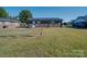 Back exterior view of a well-kept lawn and a brick home with a door and two windows at 1108 Pearson Dr, Rock Hill, SC 29730
