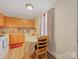 Eat-in kitchen boasting wood cabinetry, laminate countertops, a table, and a window at 1108 Pearson Dr, Rock Hill, SC 29730