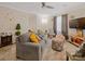 Comfortable living room featuring a gray sofa with pillows, neutral walls, and a mounted TV at 1108 Pearson Dr, Rock Hill, SC 29730
