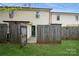 Fenced backyard features a green lawn, gate, and access to the home, creating a secure and inviting outdoor area at 1113 Keswick Pl # 118, Monroe, NC 28112