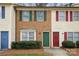Townhomes featuring brick and siding facades with colorful shutters and doors at 1113 Keswick Pl # 118, Monroe, NC 28112