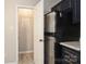 A kitchen area features an stainless steel refrigerator, granite countertops, black cabinets, and a pantry at 1113 Keswick Pl # 118, Monroe, NC 28112