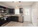 Bright kitchen with stainless steel appliances, dark cabinetry, and modern fixtures at 1113 Keswick Pl # 118, Monroe, NC 28112