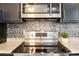 Close up of a modern kitchen featuring stainless steel appliances, granite countertops, and stylish backsplash at 1113 Keswick Pl # 118, Monroe, NC 28112