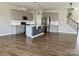 Spacious open kitchen with grey cabinetry, an island with a sink and stainless steel appliances at 11220 Westbranch Pkwy, Davidson, NC 28036