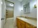 Bathroom features a vanity with a countertop, a framed mirror, and a tiled floor leading to the shower at 12011 Stoney Meadow Dr, Mint Hill, NC 28227