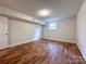 Bedroom featuring wood flooring and a window that lets in natural light to brighten the space at 12011 Stoney Meadow Dr, Mint Hill, NC 28227