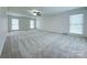 A roomy, carpeted bedroom featuring natural light from large windows at 12011 Stoney Meadow Dr, Mint Hill, NC 28227