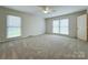 Large primary bedroom featuring neutral carpet, natural light, and a ceiling fan at 12011 Stoney Meadow Dr, Mint Hill, NC 28227