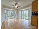 Bright dining area with bay windows offering picturesque views and a modern ceiling fan at 12011 Stoney Meadow Dr, Mint Hill, NC 28227