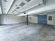 Spacious garage with ample room for storage and vehicles, plus a convenient service door at 12011 Stoney Meadow Dr, Mint Hill, NC 28227