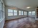Spacious living room featuring lots of natural light, sleek floors, and modern track lighting at 12011 Stoney Meadow Dr, Mint Hill, NC 28227