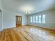 Bright living room showcasing hardwood floors, neutral paint, and a large bay window at 12011 Stoney Meadow Dr, Mint Hill, NC 28227