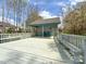 Charming pool house with a covered deck, seating, and storage space for poolside convenience at 12011 Stoney Meadow Dr, Mint Hill, NC 28227