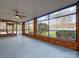 Sunroom with brick walls and large windows with a view of the yard and trees at 12011 Stoney Meadow Dr, Mint Hill, NC 28227