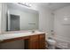 Functional bathroom features wood cabinets, a large mirror, and a shower-tub combination at 125 Colville Rd, Mooresville, NC 28117