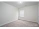 Cozy bedroom featuring plush carpeting and a bright window, offering a comfortable retreat at 125 Colville Rd, Mooresville, NC 28117