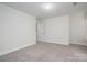 Spacious bedroom with neutral walls, plush carpeting and natural light from a window at 125 Colville Rd, Mooresville, NC 28117
