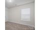 Bright bedroom with neutral walls, plush carpeting, and a window that provides natural light at 125 Colville Rd, Mooresville, NC 28117