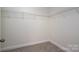 Walk-in closet featuring sturdy white shelving for optimal storage and carpeted flooring at 125 Colville Rd, Mooresville, NC 28117