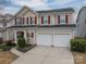 Charming two-story home featuring a two-car garage, red shutters, and well-maintained landscaping at 125 Colville Rd, Mooresville, NC 28117