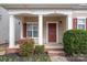 Inviting front porch with decorative columns, brick steps, and colorful landscaping at 125 Colville Rd, Mooresville, NC 28117