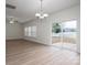Bright and airy living area featuring new floors, a ceiling fan, and a sliding door to the backyard at 125 Colville Rd, Mooresville, NC 28117