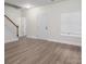 Bright living room with staircase, and a front door, all complemented by luxury vinyl plank flooring at 125 Colville Rd, Mooresville, NC 28117