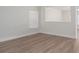 Spacious living room with neutral walls, base molding, and large window with horizontal blinds at 125 Colville Rd, Mooresville, NC 28117