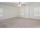 Spacious bedroom with neutral walls, ceiling fan, and two large windows with horizontal blinds at 125 Colville Rd, Mooresville, NC 28117