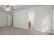 Neutral-toned bedroom features an ensuite bathroom, ceiling fan, and carpet flooring at 125 Colville Rd, Mooresville, NC 28117