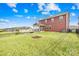 Spacious backyard with green lawn, black fencing, and view of rear exterior at 12706 Heath Grove Dr, Huntersville, NC 28078