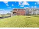 Expansive backyard with green grass, fenced perimeter, and view of the covered patio at 12706 Heath Grove Dr, Huntersville, NC 28078