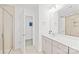Well-lit bathroom with tiled shower, vanity with sink, and doorway to separate room at 12706 Heath Grove Dr, Huntersville, NC 28078