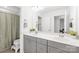 Clean, well-lit bathroom with double vanity and gray cabinets at 12706 Heath Grove Dr, Huntersville, NC 28078
