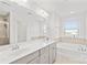Bright bathroom featuring double vanity, soaking tub, and a separate glass-enclosed shower at 12706 Heath Grove Dr, Huntersville, NC 28078