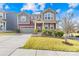 Charming two-story home with a well-manicured lawn, inviting front porch, and neutral-toned color scheme at 12706 Heath Grove Dr, Huntersville, NC 28078