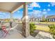 Charming covered front porch with stone columns and cozy seating area overlooking the street at 12706 Heath Grove Dr, Huntersville, NC 28078