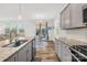 The kitchen seamlessly connects to the living room and dining area, creating an open and inviting atmosphere at 12706 Heath Grove Dr, Huntersville, NC 28078
