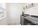 Tidy laundry room with a window and modern washer and dryer at 12706 Heath Grove Dr, Huntersville, NC 28078
