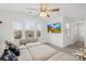Bright and open living room features large windows and a ceiling fan at 12706 Heath Grove Dr, Huntersville, NC 28078