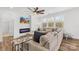 Bright living room with large sectional sofa, modern fireplace, and view of backyard at 12706 Heath Grove Dr, Huntersville, NC 28078