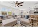 Open-concept living room with a large sectional, connecting to a kitchen and dining area at 12706 Heath Grove Dr, Huntersville, NC 28078