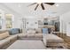 Spacious living room featuring a large sectional sofa and open layout connected to the kitchen at 12706 Heath Grove Dr, Huntersville, NC 28078