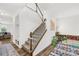 Inviting staircase with wood banister, leading to a bright, open living area, with room accents at 12706 Heath Grove Dr, Huntersville, NC 28078