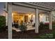 Inviting back patio with comfortable seating and pergola boasts a seamless indoor-outdoor living experience at 12912 Bailey Rd, Cornelius, NC 28031