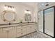 Elegant bathroom featuring double sink vanities, decorative tile floor, and a glass-enclosed shower at 12912 Bailey Rd, Cornelius, NC 28031