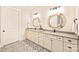 Charming bathroom with double vanities, wood-framed mirrors, and decorative tiled floor at 12912 Bailey Rd, Cornelius, NC 28031