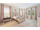 Cozy bedroom with neutral colors and natural light from multiple windows and pink curtains at 12912 Bailey Rd, Cornelius, NC 28031